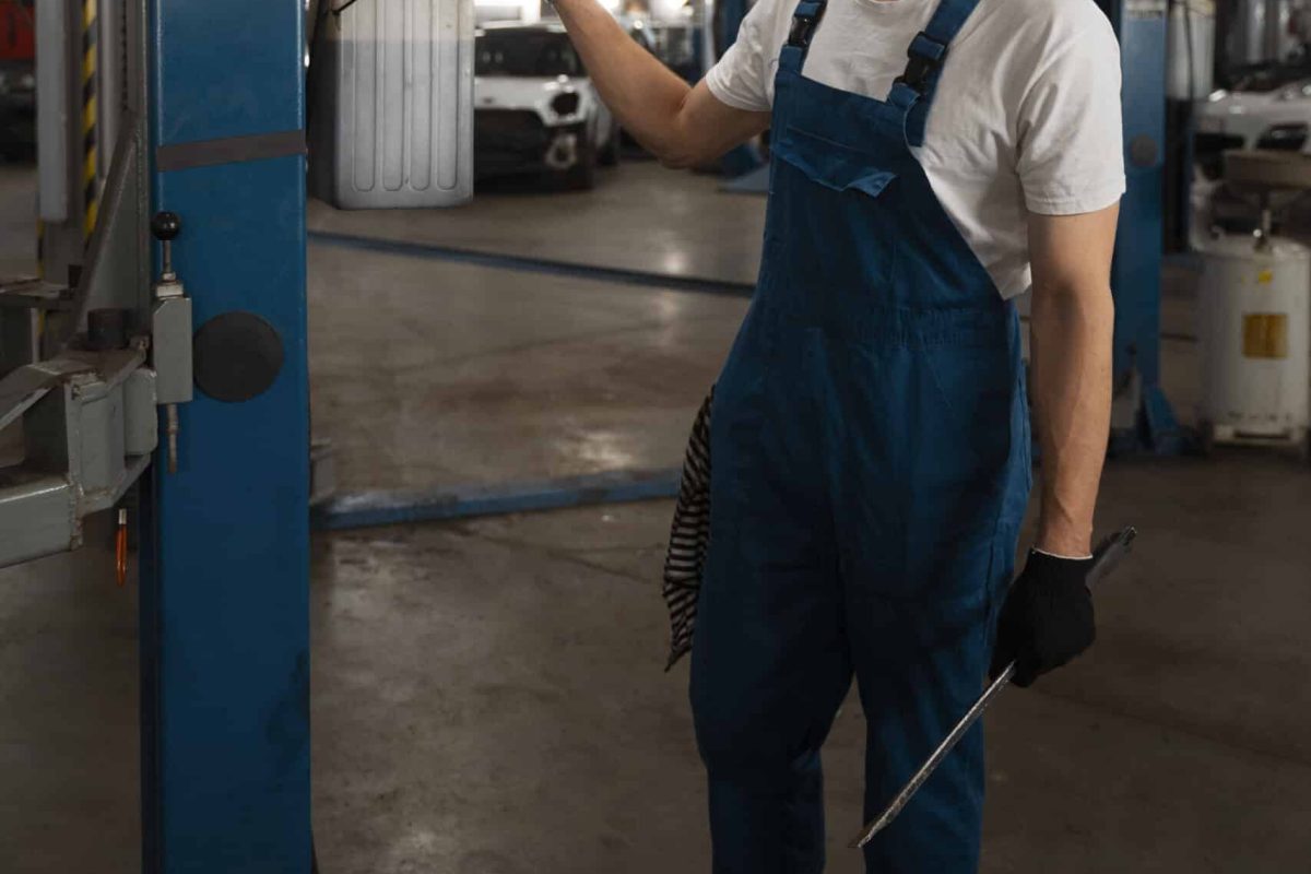 male-mechanic-working-shop-car